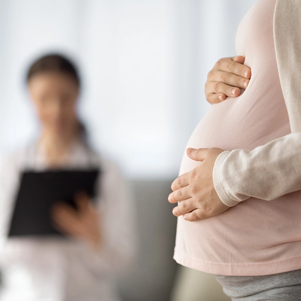 Close up of woman expecting baby having appointment with doctor at antenatal clinic prenatal healthcare center